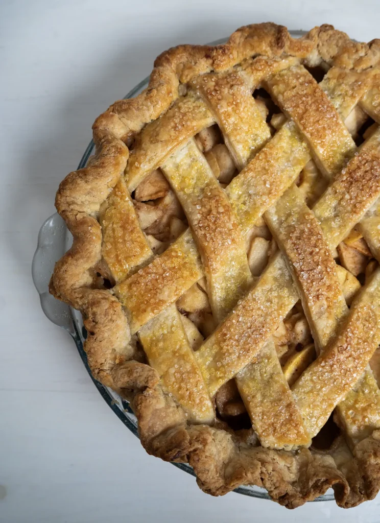 Top view of a miso caramel apple pie with a lattice crust.