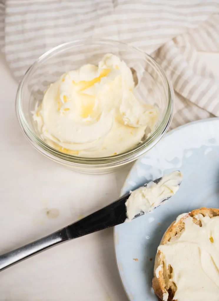 Homemade mascarpone cheese spread on a toasted english muffin.