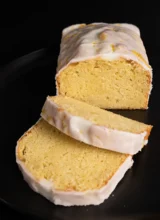 Sliced loaf of glazed lemon pound cake.