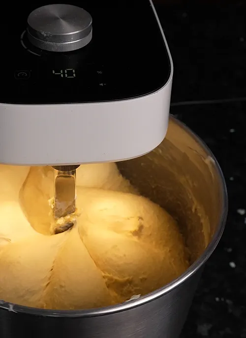 Enriched sourdough recipe being kneaded in a spiral dough mixer.