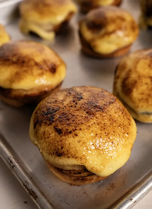 Crème Brûlée Cinnamon Rolls on a baking sheet.