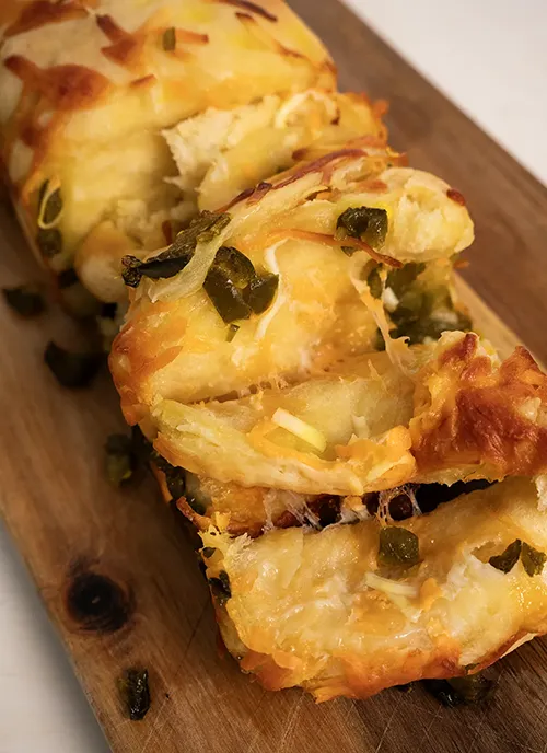 Jalapeño Cheddar Pull-Apart Loaf on a wooden cutting board.